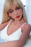 The image shows a highly realistic sex doll named Garin, with long blonde hair and a white dress. The doll has a lifelike appearance with detailed facial features and is seated, presenting a lifelike and engaging presence.